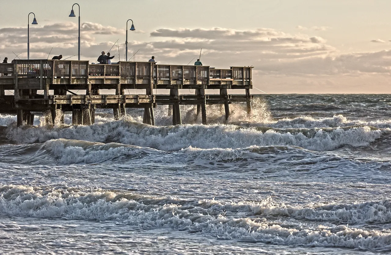 Waves crashing against a wooden pier.