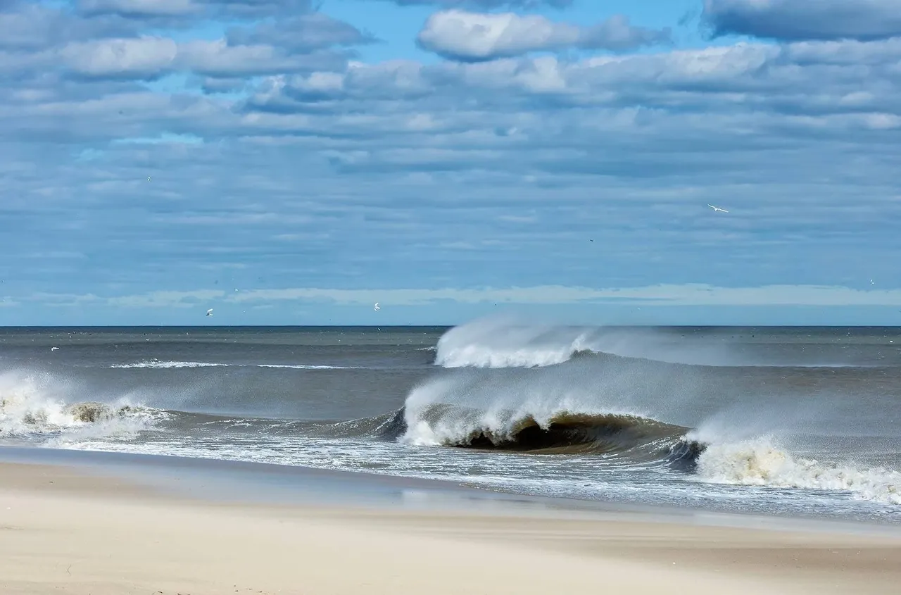 Waves crashing on a sandy beach.