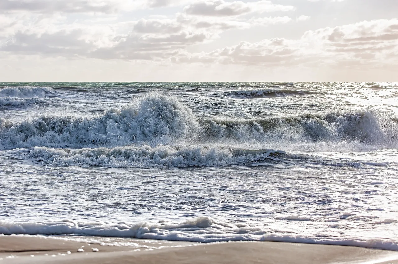 Waves crashing on a sandy beach.