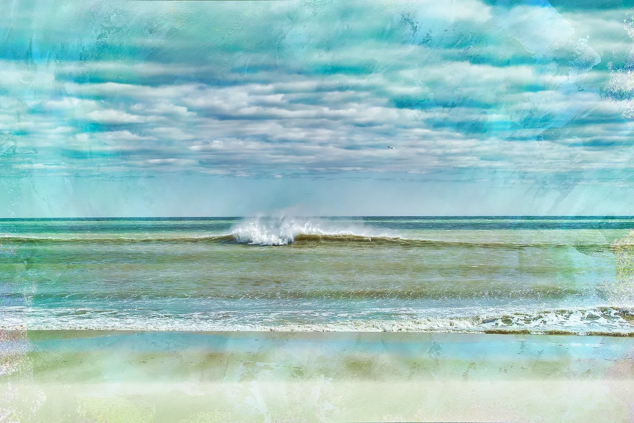 Ocean waves under a cloudy sky.
