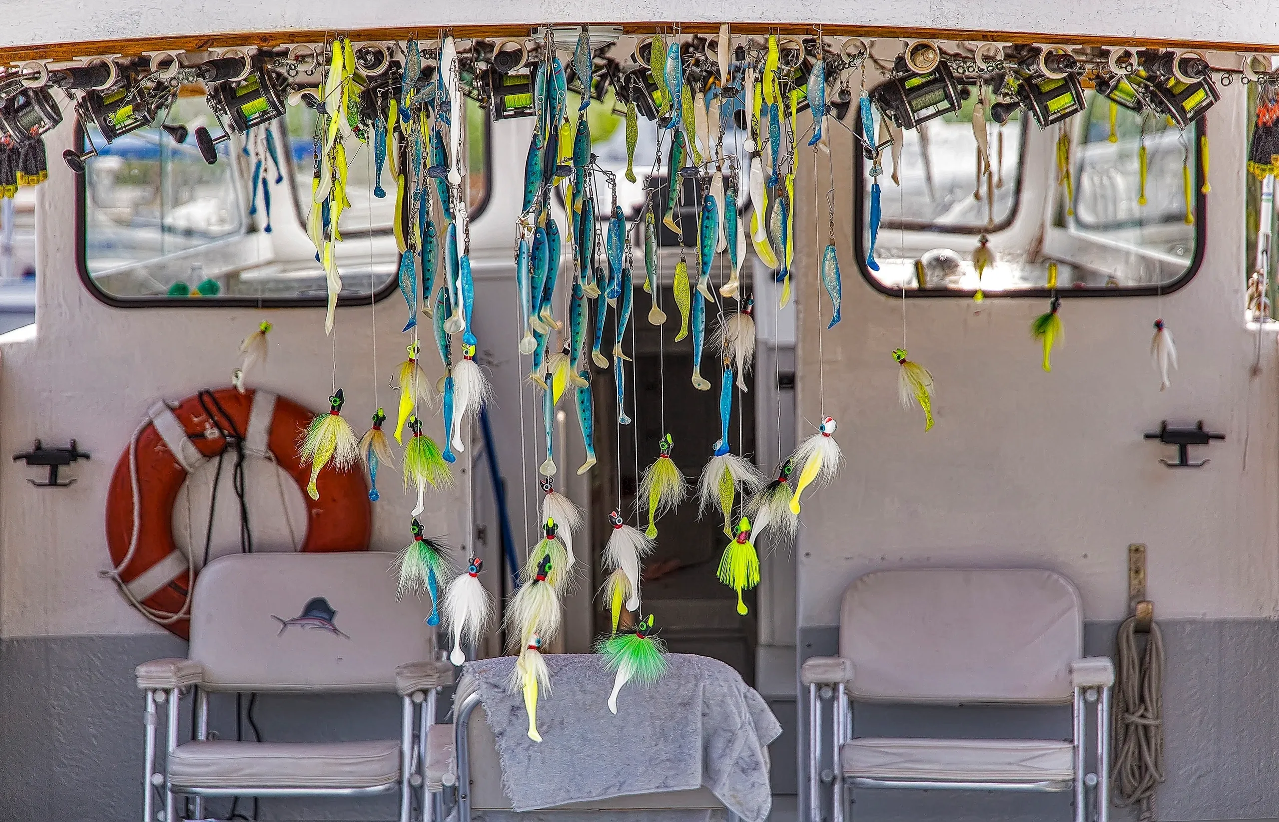 Fishing lures hanging inside a boat.