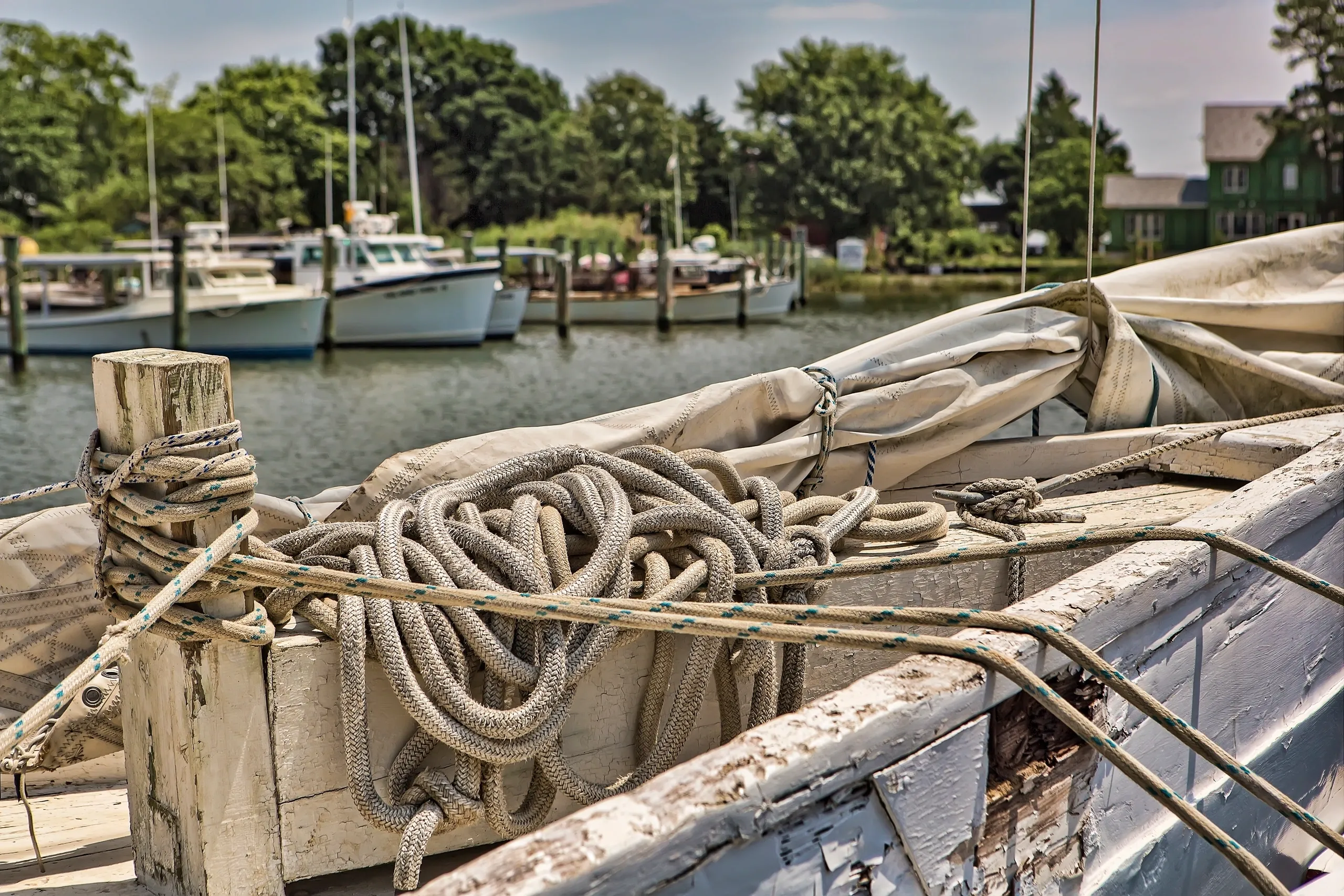 Old boat with ropes by the dock.