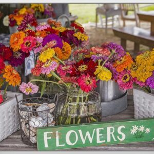 A colorful bouquet of fresh flowers in rustic containers with a 'FLOWERS' sign.
